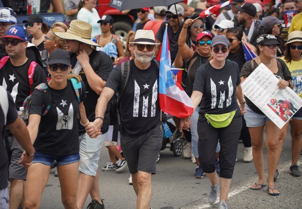 Demonstrators walk down the Las Americas Expressway, the biggest highway in Puerto Rico as part of a massive march on July 22, 2019 in San Juan, Puerto Rico. There have been calls for the governor to step down after it was revealed that he and top aides were part of a private chat group that contained, among other messages, misogynistic and homophobic messages. (Photo by Angel Valentin/Getty Images)